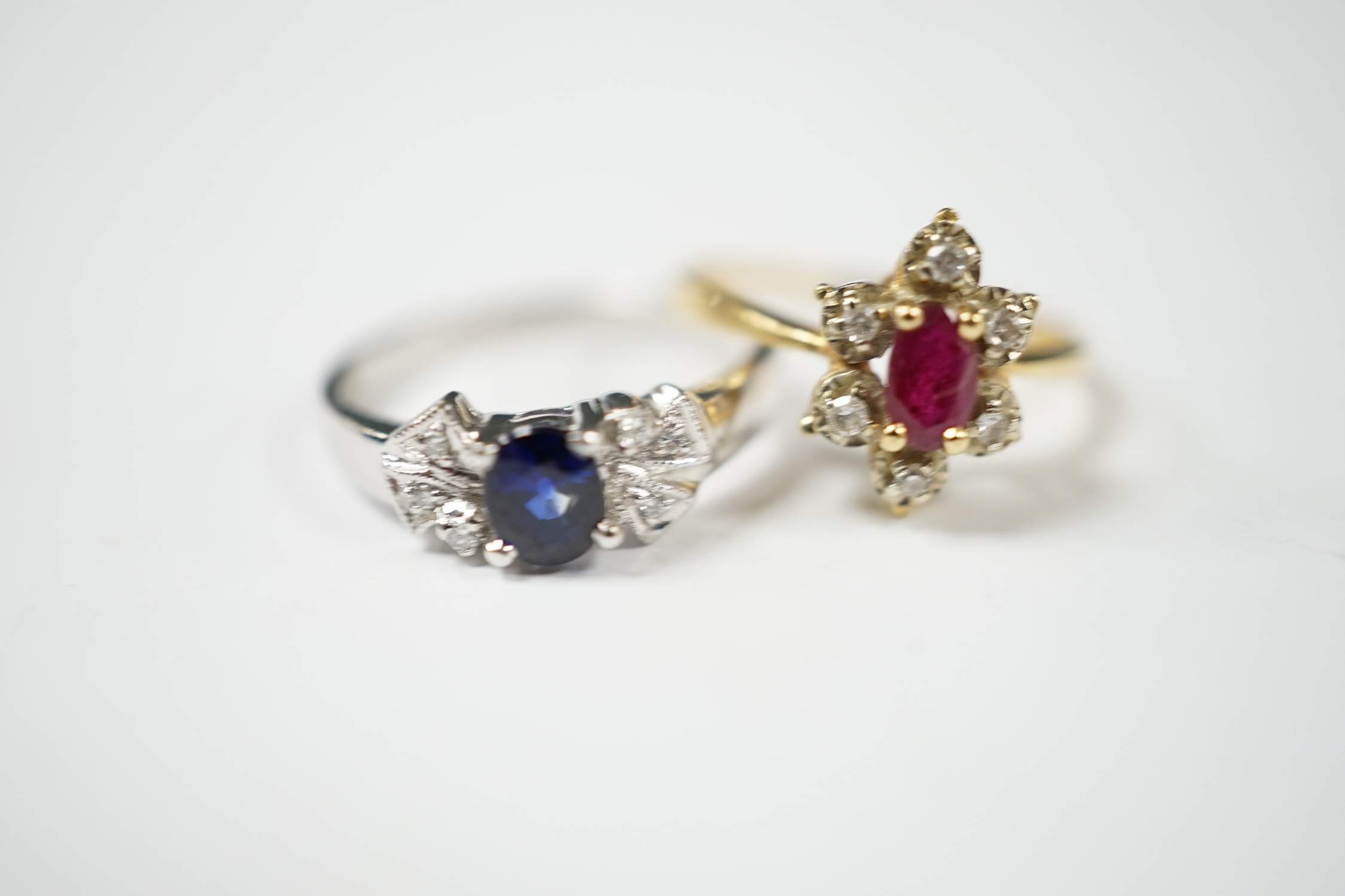 A French 18k, ruby and diamond set flower head cluster ring, size J and an 18k white metal, sapphire and diamond chip set ring, gross weight 4.8 grams. Condition - fair